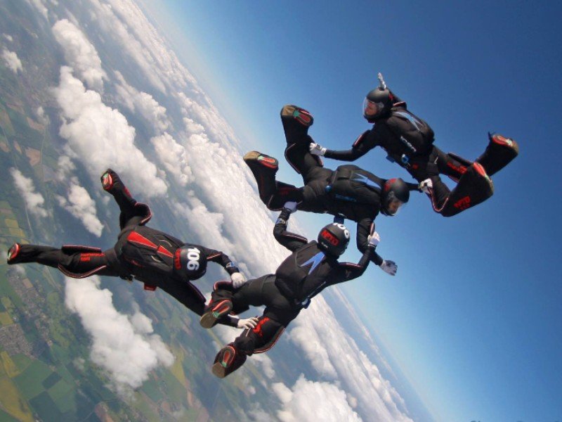 Instructors Helping Learner To Skydive